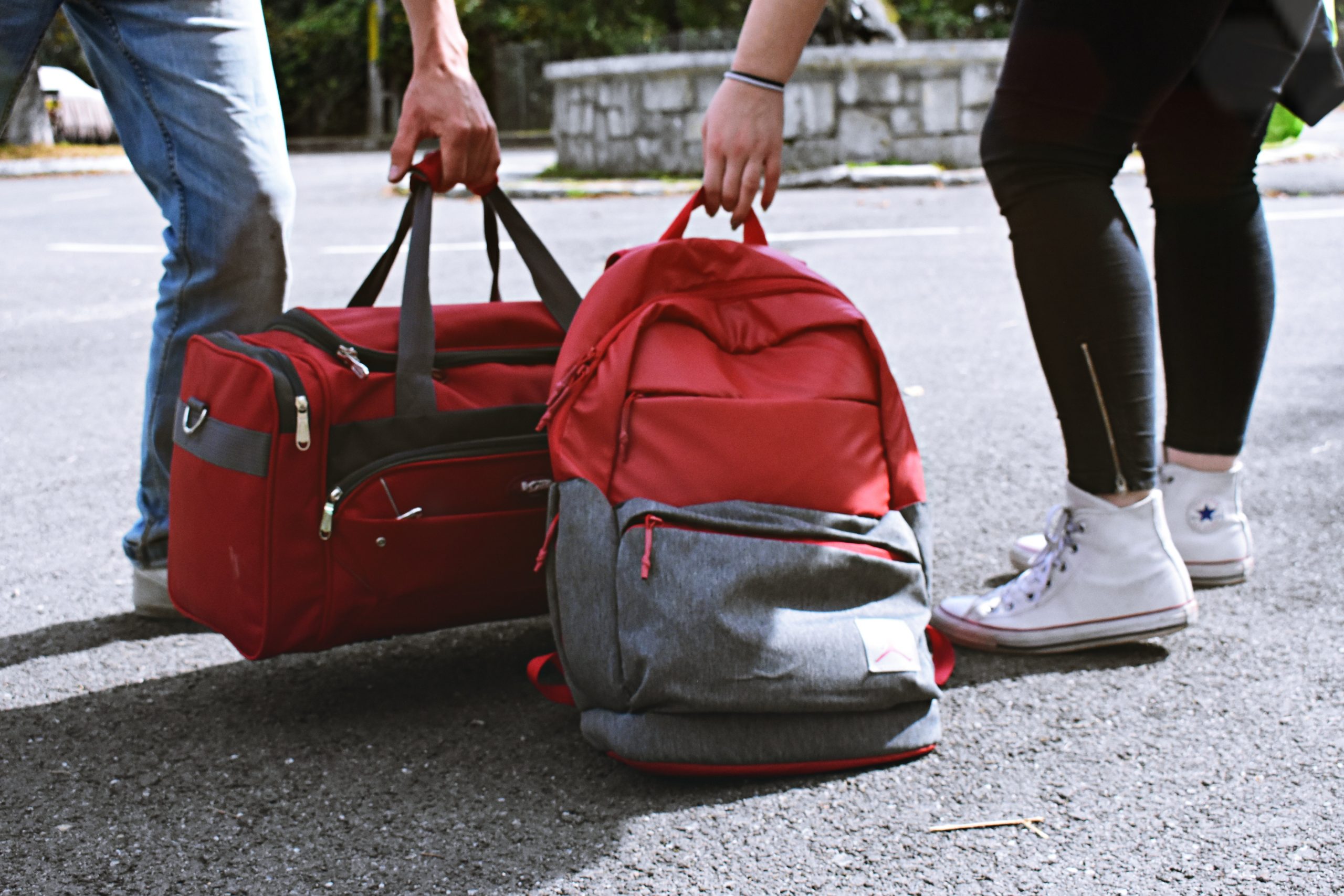 Duffel bag and backpack on floor